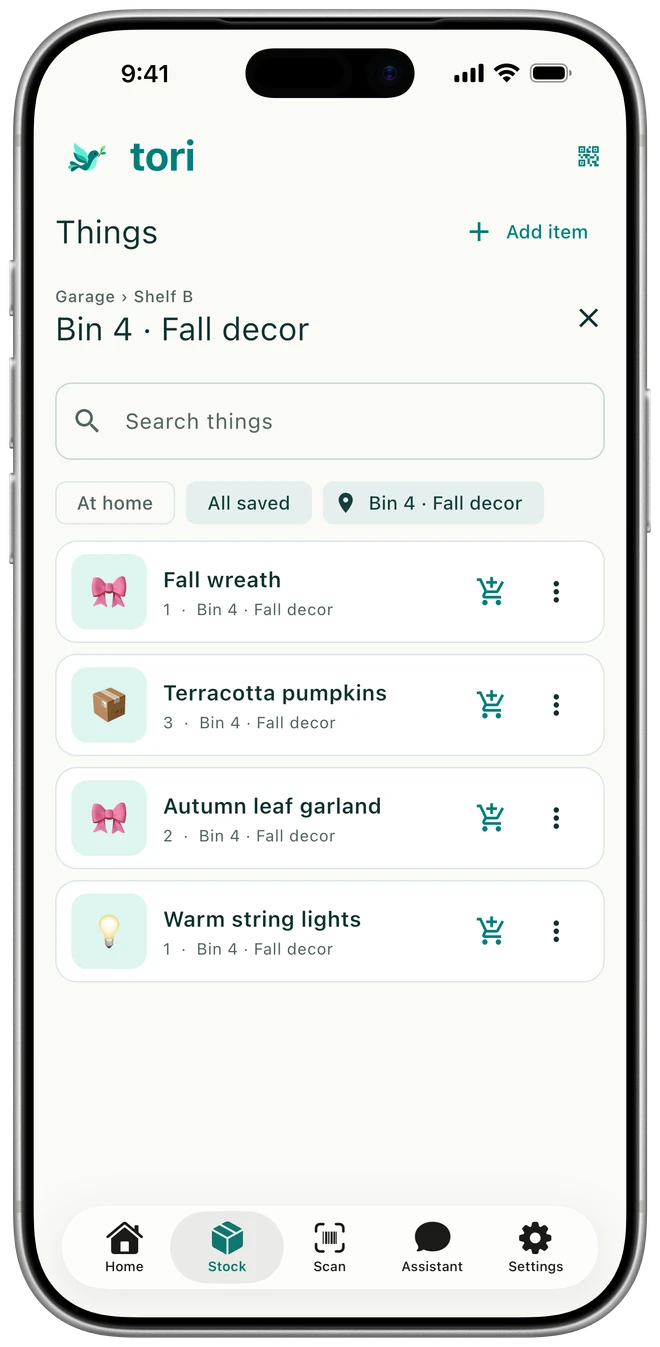 Tori shows Garage, Shelf B, and Bin 4 — Fall decor, with a wreath, pumpkins, garland, and string lights.